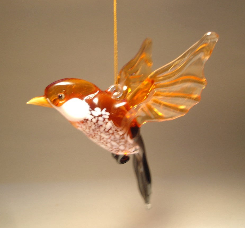 A front view of a glass sparrow ornament figurine, showcasing its detailed features, including a finely crafted beak and wings.