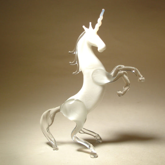 A front view of a glass white unicorn figurine, showcasing its majestic horn, flowing mane, and detailed features.