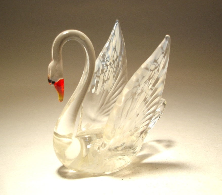 Side view of the white and clear glass swan, showcasing its graceful neck and semi-open wings.