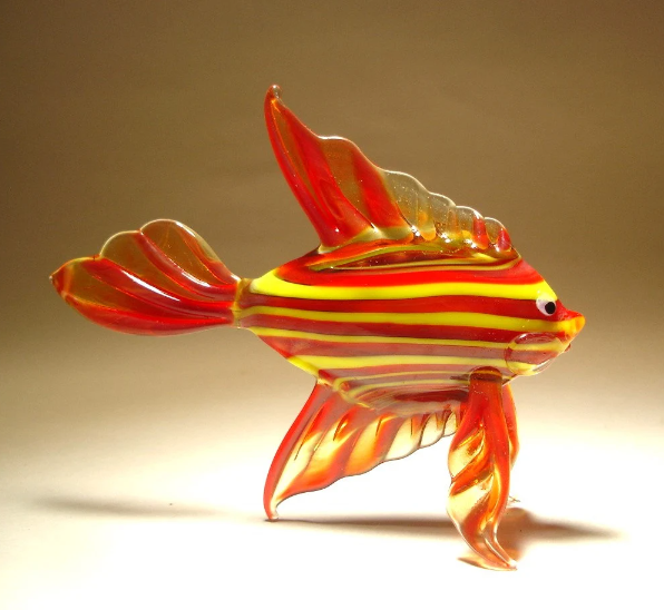 A front view of a red glass tropical fish figurine with bold yellow stripes, featuring a detailed fin and tail design.