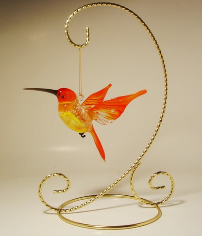 The stand for glass ornaments with a red hummingbird hanging as an example.